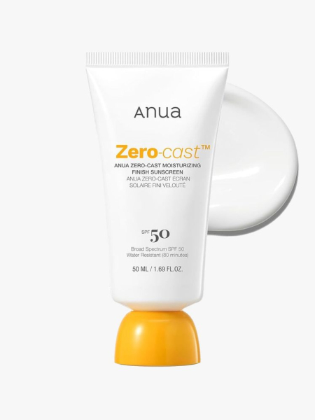 A white tube of Anua Zero-Cast Moisturizing Finish Sunscreen SPF 50 with an orange cap on a light gray background